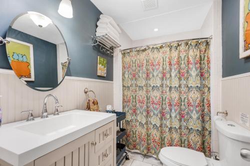 a bathroom with a sink and a shower curtain at Bluebird Cottage, 1897 Home On Salida's Alpinepark in Salida