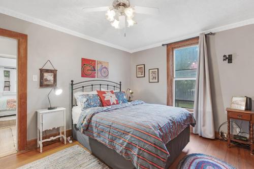 a bedroom with a bed and a window at Bluebird Cottage, 1897 Home On Salida's Alpinepark in Salida