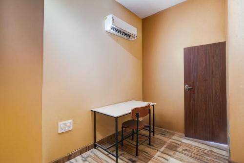 a small room with a table and a door at Hotel O Euphoria inn in Morādābād