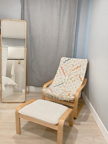 a room with a chair and a mirror at Comfort Meets Convenience in Schaumburg