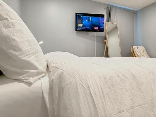 a bedroom with a bed with a tv on the wall at Comfort Meets Convenience in Schaumburg