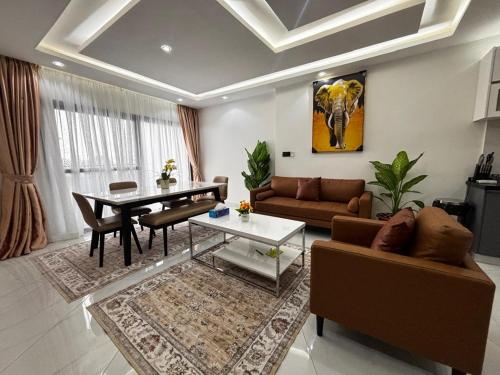 a living room with a couch and a table in it at Stunning 2 Bedroom Apartment Overlooking the Ocean in Dakar