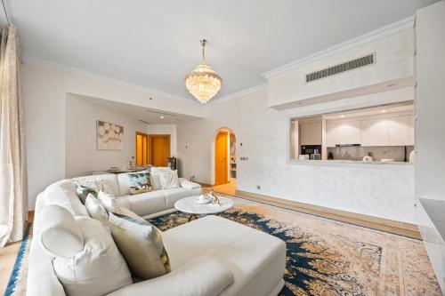a living room with a white couch and a table at 2BDR Luxury Apartment in Palm in Dubai