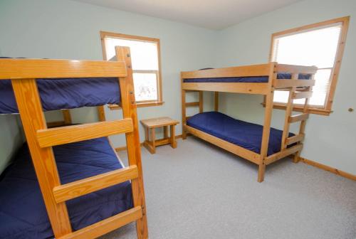 a room with two bunk beds and a table at Shore Is Fun in Duck
