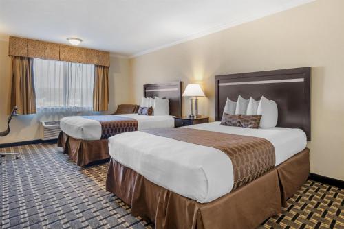 a hotel room with two beds in a room at Best Western PLUS Inn of Hayward in Hayward