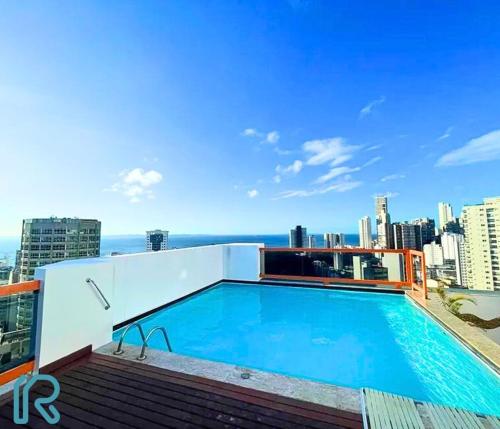a swimming pool on the roof of a building at Quarto e Sala completo com Cozinha, Ar condicionado, Wifi e Camareira in Salvador
