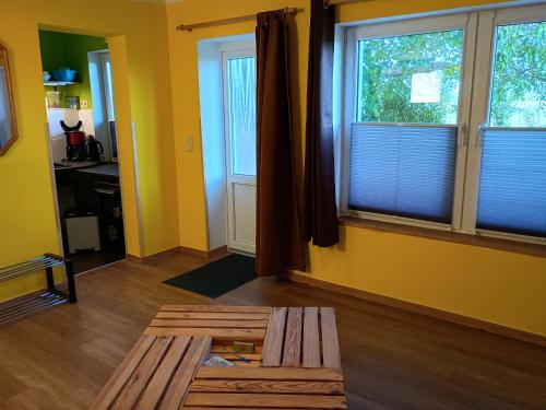 a living room with a table and two windows at Rast im Grünen in Gotthun