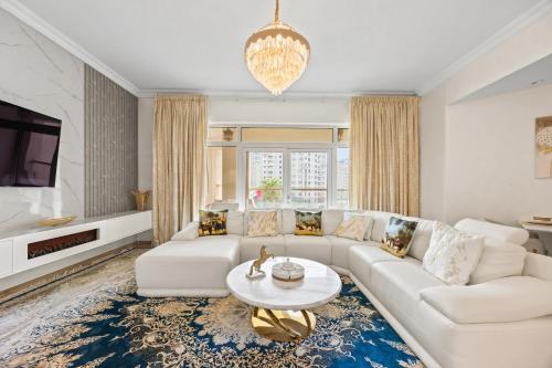 a living room with a white couch and a table at 2BDR Luxury Apartment in Palm in Dubai