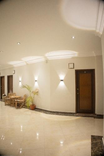 a lobby with a table and chairs and lights at Bright Moon in Dahab