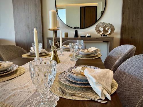 a dining room table with chairs and a mirror at Fins Dream Villas in Fins