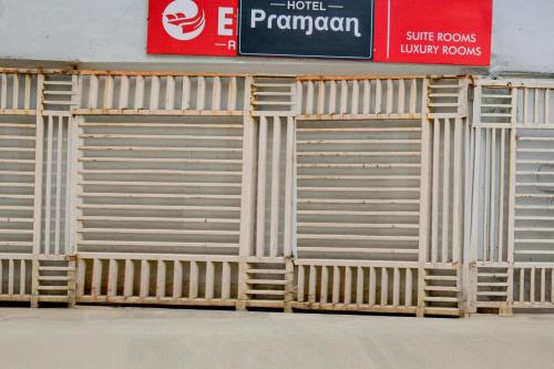a set of wooden garage doors on the side of a building at Hotel O The Pramaan in Kukatpalli
