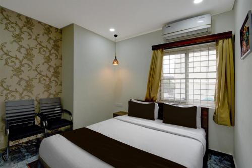 a hotel room with a bed and a window at Hotel O The Pramaan in Kukatpalli