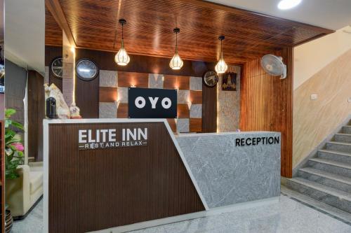 a lobby with a exit inn sign and stairs at Hotel O The Pramaan in Kukatpalli