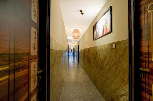 a hallway in a building with a long corridor at Hotel O The Pramaan in Kukatpalli