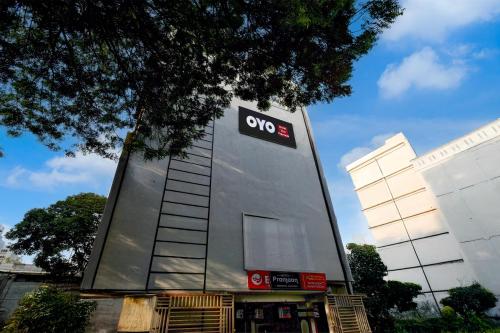 a building with aneyes sign on the side of it at Hotel O The Pramaan in Kukatpalli