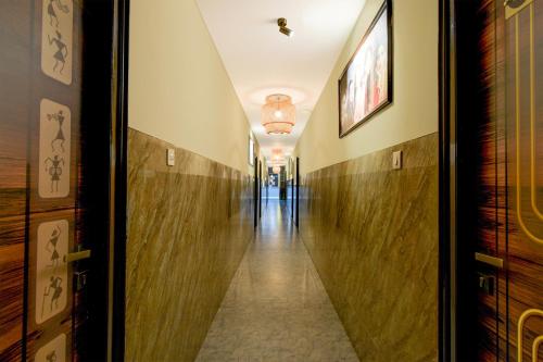 a hallway in a building with a long corridor at Hotel O The Pramaan in Kukatpalli
