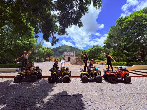 a group of people riding on four wheeled vehicles at Blue Moon Hostel in Antigua Guatemala