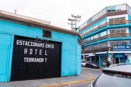 a blue building with a sign on the side of it at Hotel Terranort in Iquique
