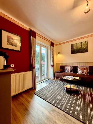 a living room with a couch and a table at AH Carinthia Mallnitz - Carinthia Appartements in Mallnitz