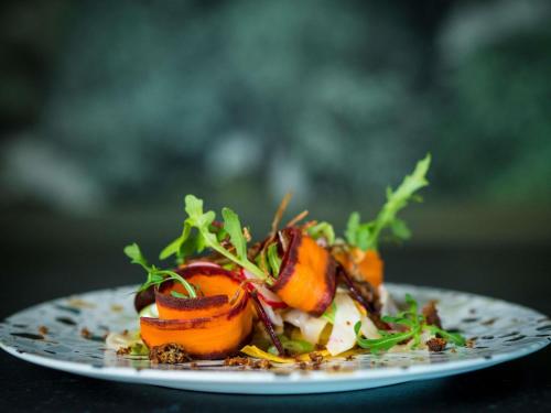 a plate of food on a table at Mercure Luxembourg Kikuoka Golf & Spa in Canach