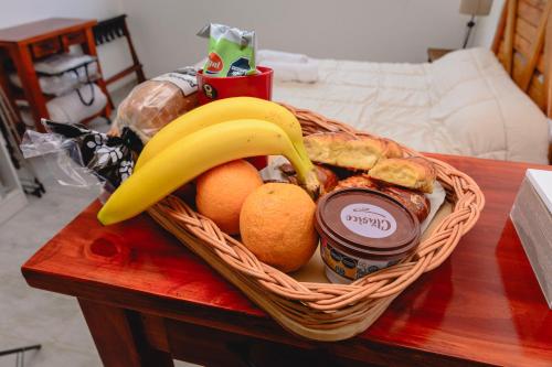 a basket of food with fruit and a banana and jam at Asturiano 6 Miramar in Miramar