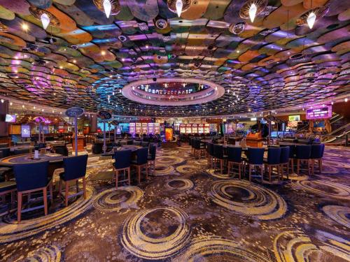 a casino with a bunch of tables and chairs at Pullman Reef Hotel Casino in Cairns