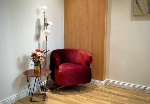 a red chair sitting in a room with a table at Fins Dream Villas in Fins