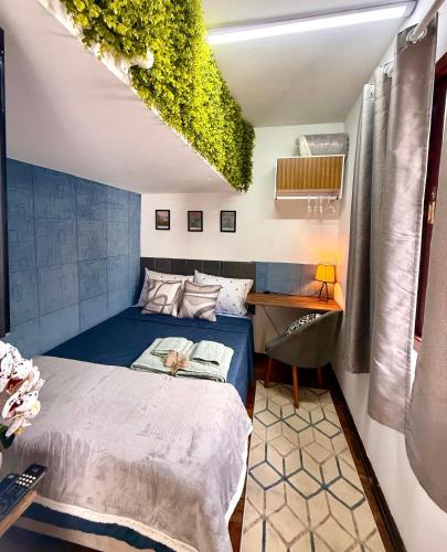 a bedroom with a bed with a plant on the ceiling at Aconchego em congonhas- CGH in Sao Paulo
