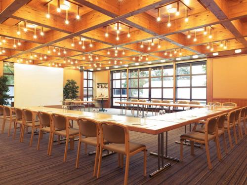a large conference room with a large table and chairs at Mercure Hotel am Messeplatz Offenburg in Offenburg