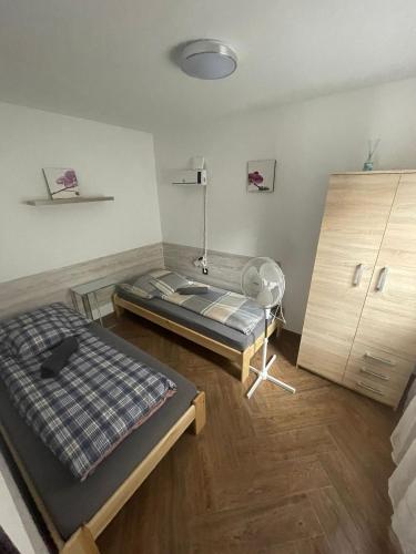 a room with a bed and a fan in it at Friendly Guesthouse Kecskemét in Kecskemét