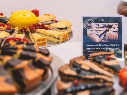 a couple of plates of desserts on a table at Mercure Roma Centro Colosseo in Rome