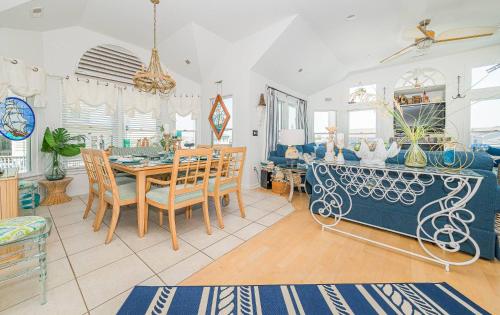 a dining room with a table and chairs at Simple Gifts by the Sea in Duck