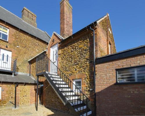a staircase on the side of a brick building at Cyril’s - Ellinbrook Apartments in Hunstanton