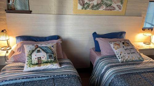 a bedroom with two beds with pillows on them at Apart Los Cerrillos in Balcarce