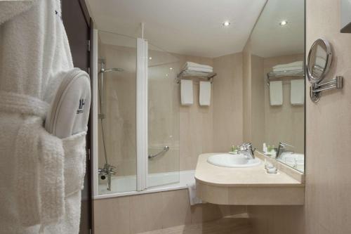 a bathroom with a sink and a shower at NH Imperial Playa in Las Palmas de Gran Canaria