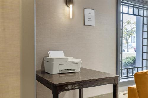 a printer sitting on a table next to a window at Best Western Potsdam University Park Inn in Potsdam