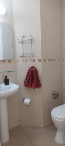 a bathroom with a sink and a toilet at Latchi coast villa-resort in Lachi