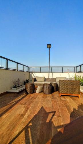 a patio with two couches on top of a building at Studio Liberdade - Próx Metrô - Sé in Sao Paulo