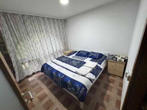 a small bedroom with a bed and a window at Kulla Guest House in Peje