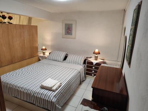 a bedroom with two beds and a dresser and a television at Jennys Vintage Studio - Motorcycle Friendly in Drama