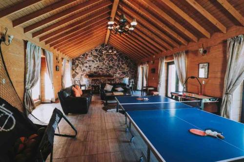 a living room with a blue table in a room at Baja Vineyard Lodge - Luxury in Valle de Guadalupe with pool in Ensenada