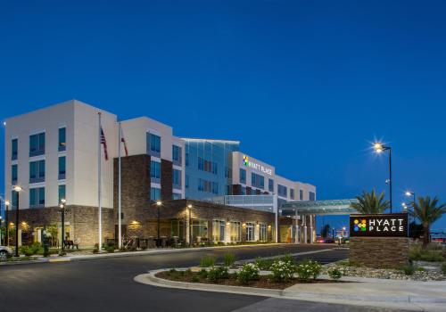 a view of a hotel at night with a street at Hyatt Place Delano in Delano