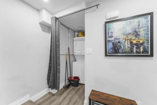 a room with a painting hanging on the wall at Modern 2-Bed, 2-Bath BSMT suite with Pvt Entrance Free Parking and Wi Fi in Pickering