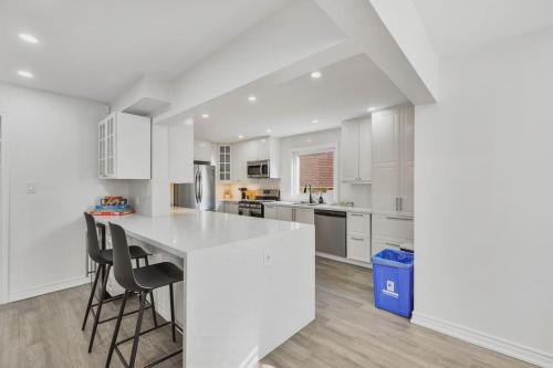 a kitchen with white cabinets and a white counter top at Luxe 4BR Retreat w Heated Pool Hot Tub and BBQ in Whitby