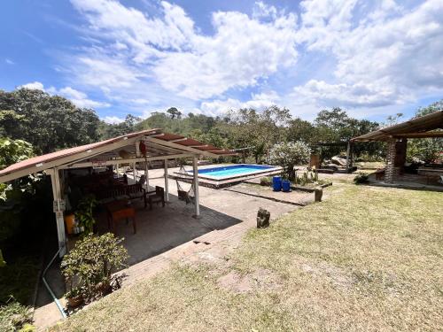 a pavilion with a pool in a yard at La Granja De Bam Bam in Sasaima