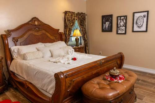 a bedroom with a large bed and a leather chair at Spacious Luxury Estate Pool Jacuzzi Horses in Orlando