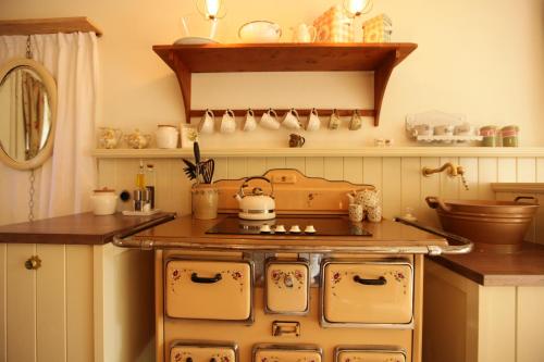 a kitchen with an old fashioned stove top oven at Weißt Du noch - Gästehäuser & Suiten in Kühlungsborn