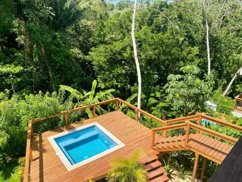 a wooden deck with a swimming pool on top of it at Villa Cass in West End