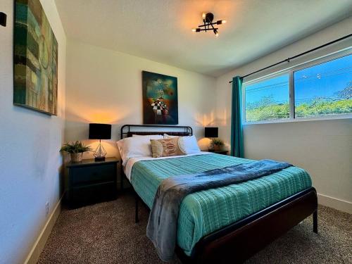 a bedroom with a bed and a window at Pool Remodeled 4 Bedroom Carmichael Home in Carmichael