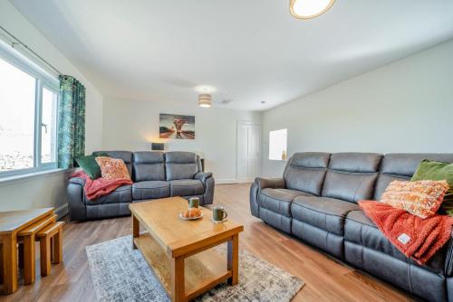a living room with a couch and a table at Greenburn in Leswalt